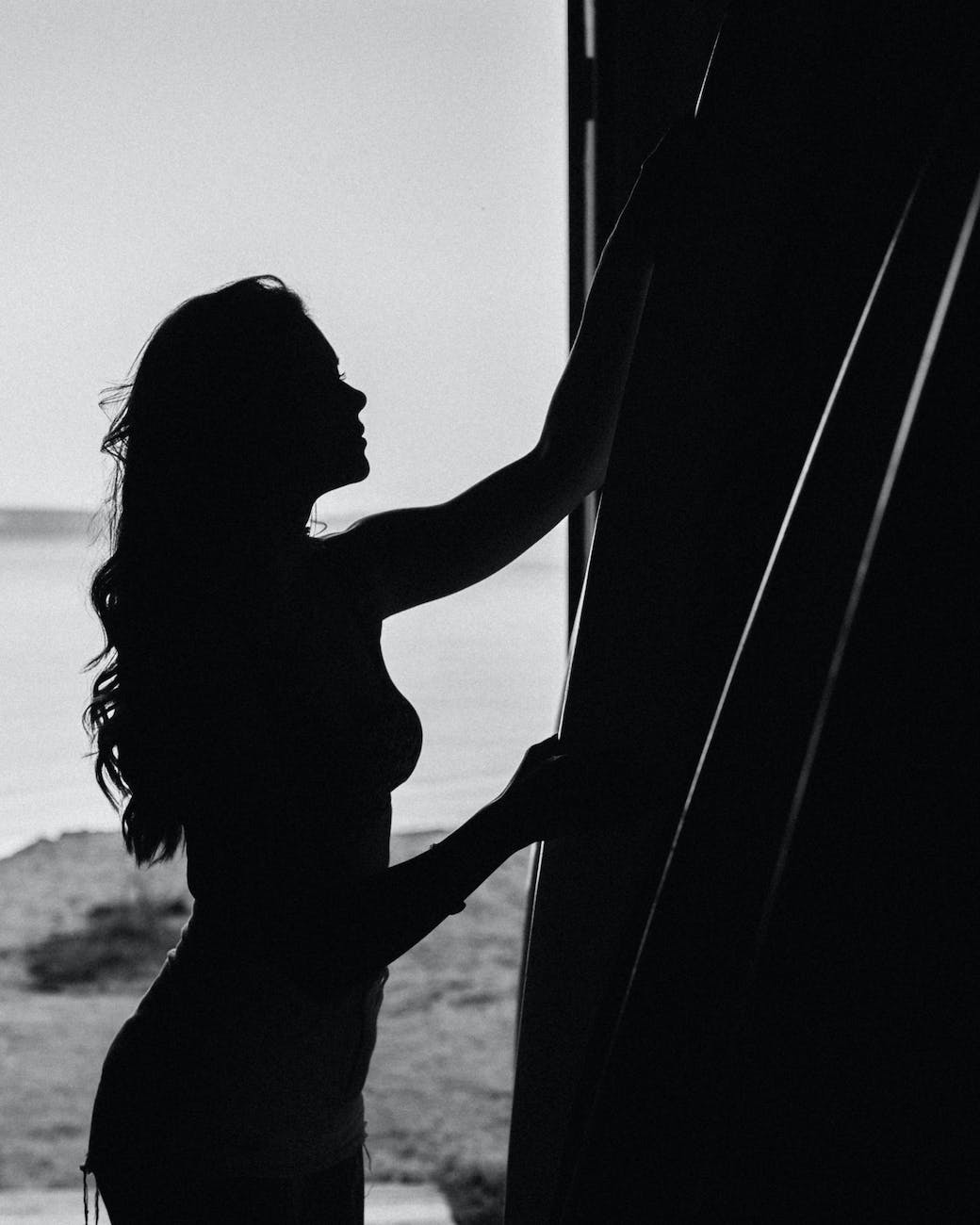 silhouette of woman standing near wall